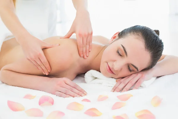Woman enjoying back massage at beauty spa