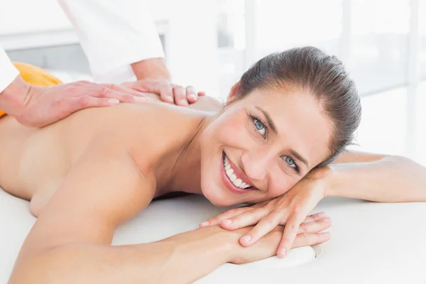 Male physiotherapist massaging woman's back