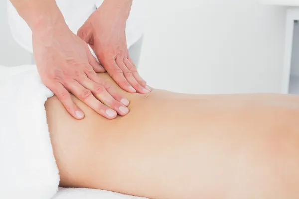 Close-up of a physiotherapist massaging woman\'s back