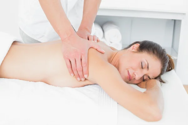 Close-up of male physiotherapist massaging woman's back