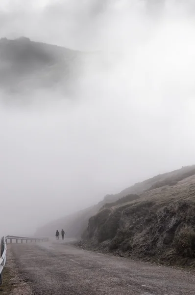 Women walking through the thick fog