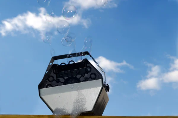 Bubble machine with blue sky