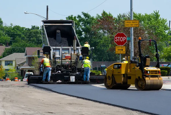 Repairing a road with hot asphalt