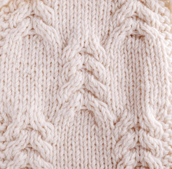 Close-up of knitted cloth with raised plaits.