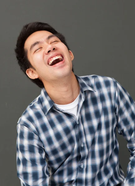 Portrait young man laughing happy face
