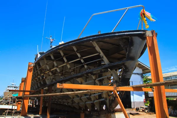 Military boat under repair and blue sky background