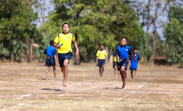 Unidentified Thai students 4 - 12 years old athletes in action during sport day