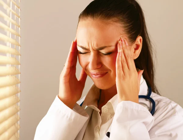 Female doctor with head pain