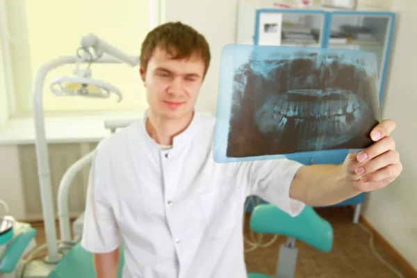 A dentist holding an x-ray
