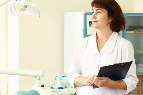 A medical doctor standing in dentist office