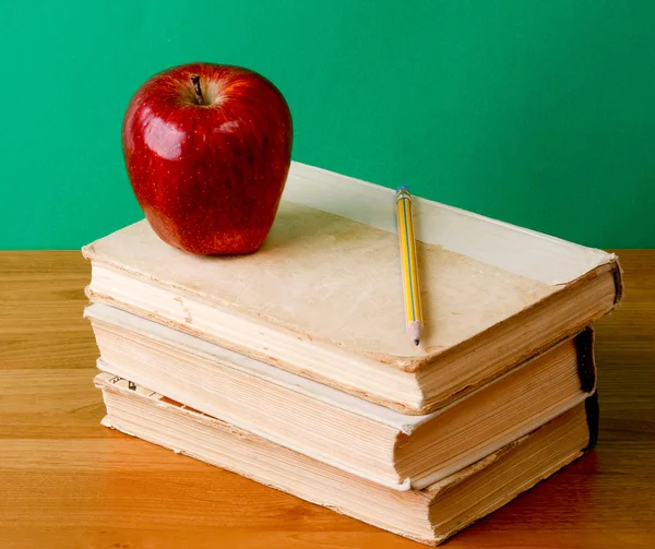 Stack of books with apple