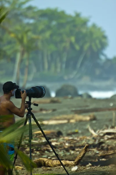 Surf photographer in action at Costa Rican beach, Pavones