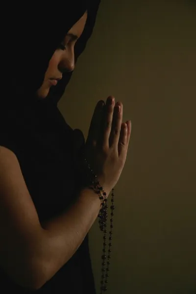 Teen Praying With Prayer Beads