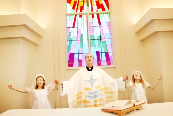 Priest With Girls On First Communion
