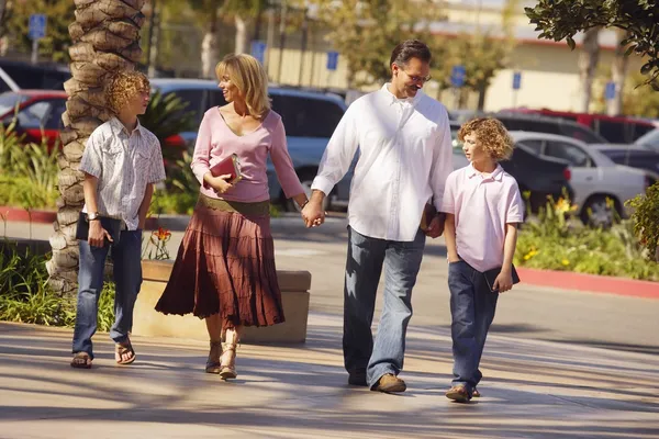 Family Carrying Bibles And Walking To Church