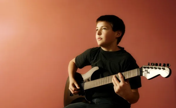 Child Holds A Guitar