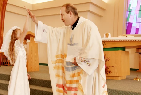 Priest Celebrates With Girl On First Communion