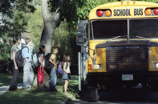 Children Loading A School Bus