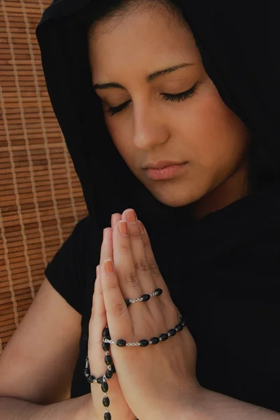 Woman Prays With Prayer Beads