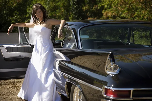 Bride Standing Outside Wedding Car