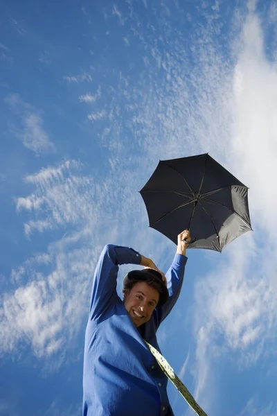 Man Being Carried Away By Umbrella