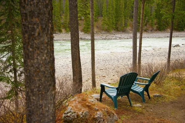 Lawn Chairs Situated By The Lake