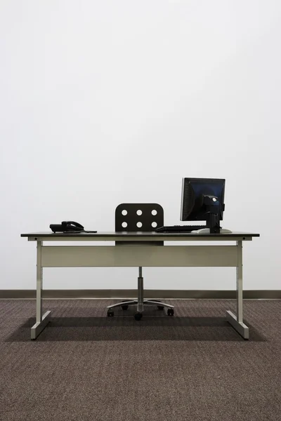 Bare Office Desk With Computer And Phone
