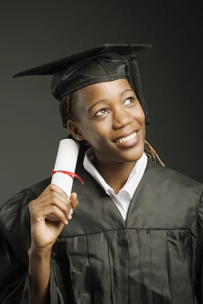 Young Woman In Cap And Gown With Diploma