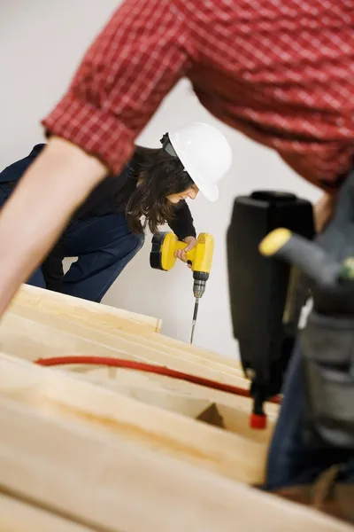 Carpenters Working With Electric Tools