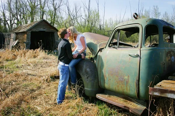 Couple Kissing On An Old Truck