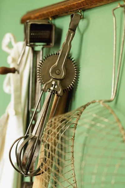 Vintage Kitchen Gadgets Hanging On A Wall