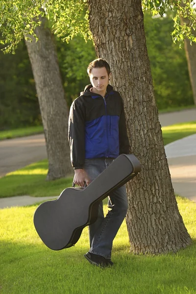 Man Posed With His Guitar Case