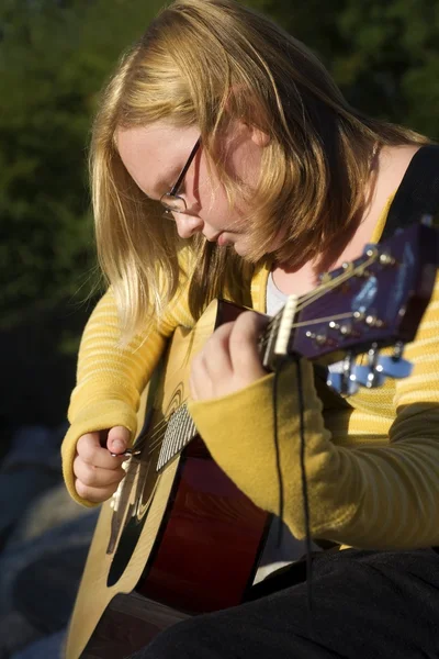 Teen Playing Guitar