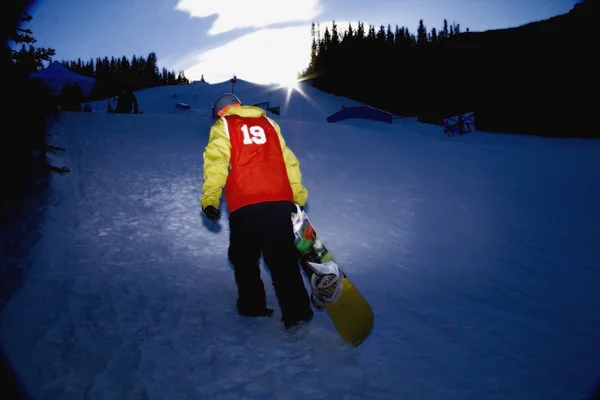 Snowboarder Climbing Up Ski Hill, Kananaskis, Alberta, Canada