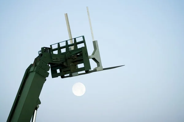 Boom Lift With Rising Moon