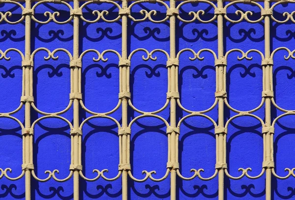 Iron railings against blue walls