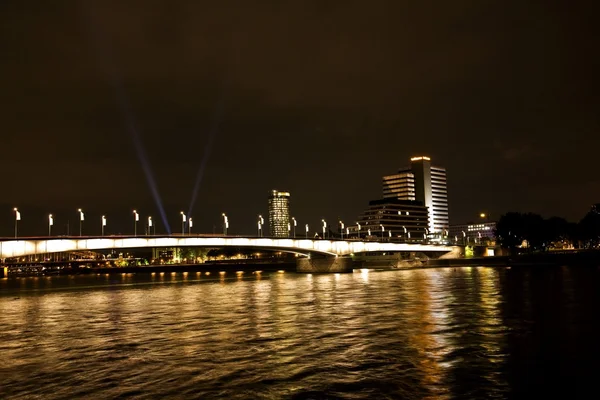 Rhine River, Germany. City Lights And Buildings By A River