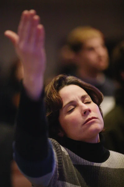 Woman Raising Hand In Worship
