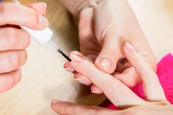 Applying clear nail polish