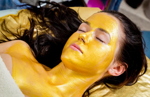 Girl makes a a golden mask