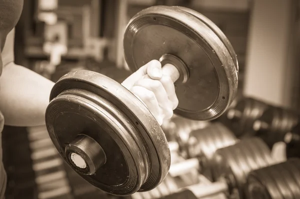 Woman holding dumbbell