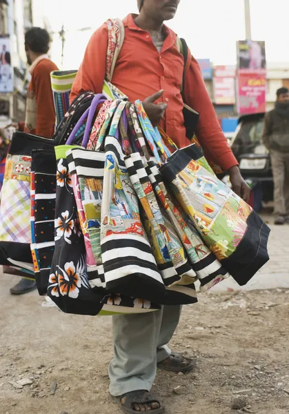 Vendor selling bags in a street market