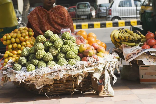 Vendor selling fruits at a market stall