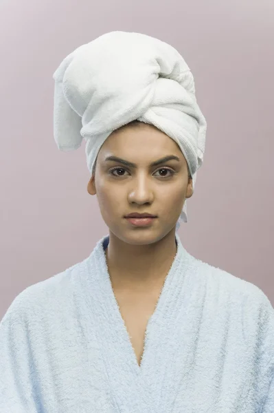 Woman with her head wrapped in a towel