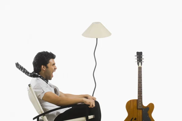 Man sitting in a chair and screaming