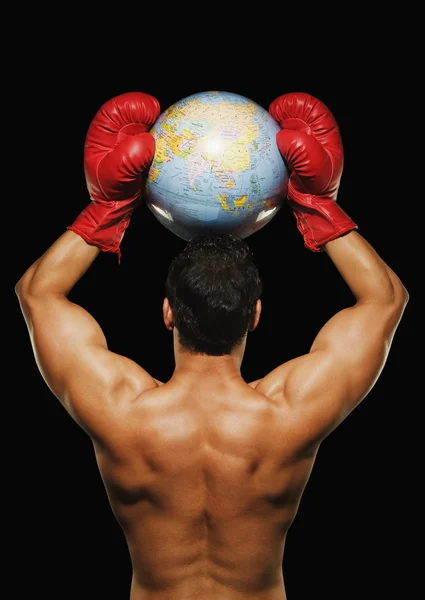Male boxer holding a globe with arms over his head