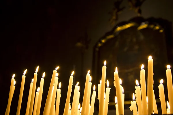 Burning votive candles in the Como Cathedral