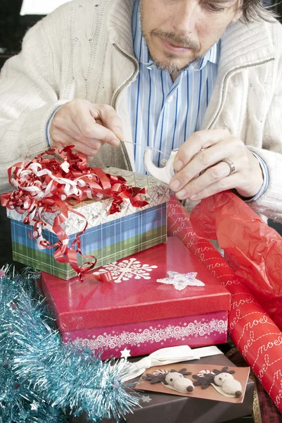 Man Concentrating On Gift Wrapping