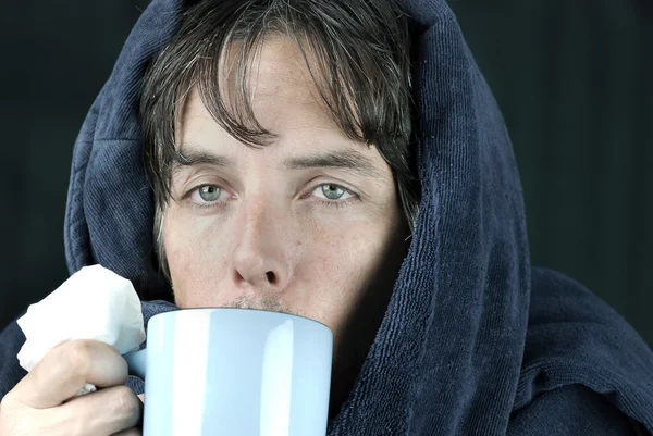 Sick Man With Tissue Drinking From Mug