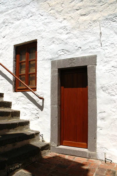 Brown door in a stone door frame